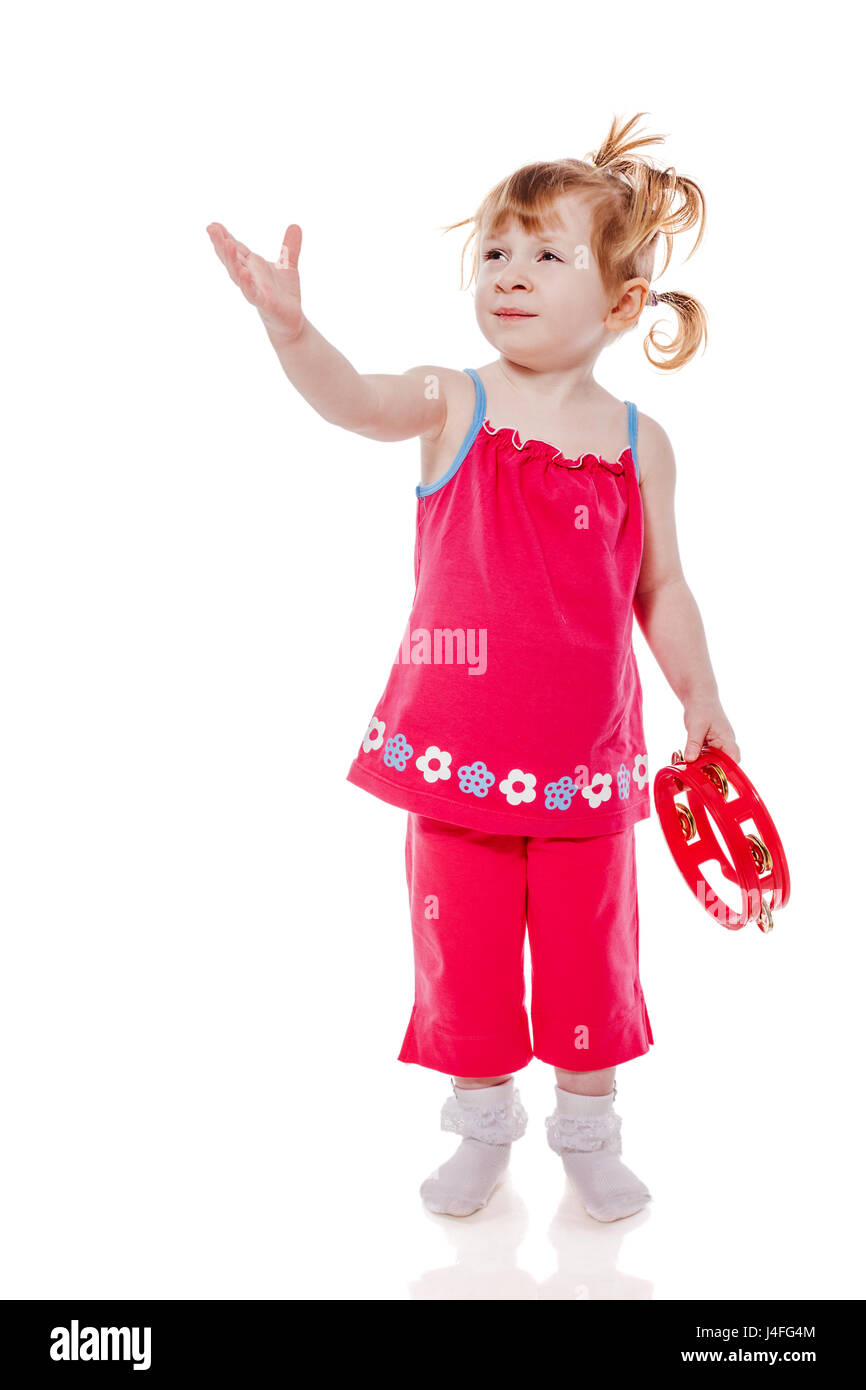Little girl playing with tambourine isolated on white Stock Photo Alamy
