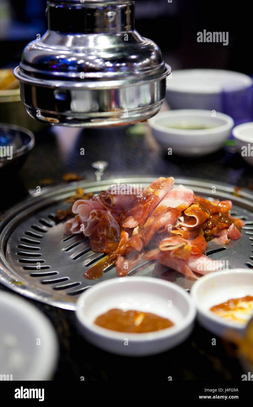 Korean Barbecue (BBQ) Table with Grill and Sides Stock Photo - Alamy