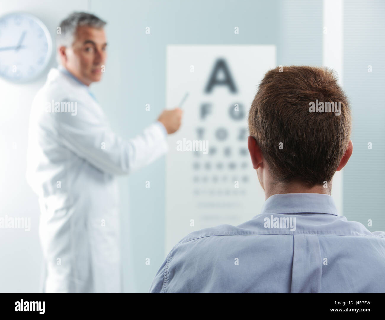 optometrist-and-patient-doctor-pointing-at-eye-chart-stock-photo-alamy