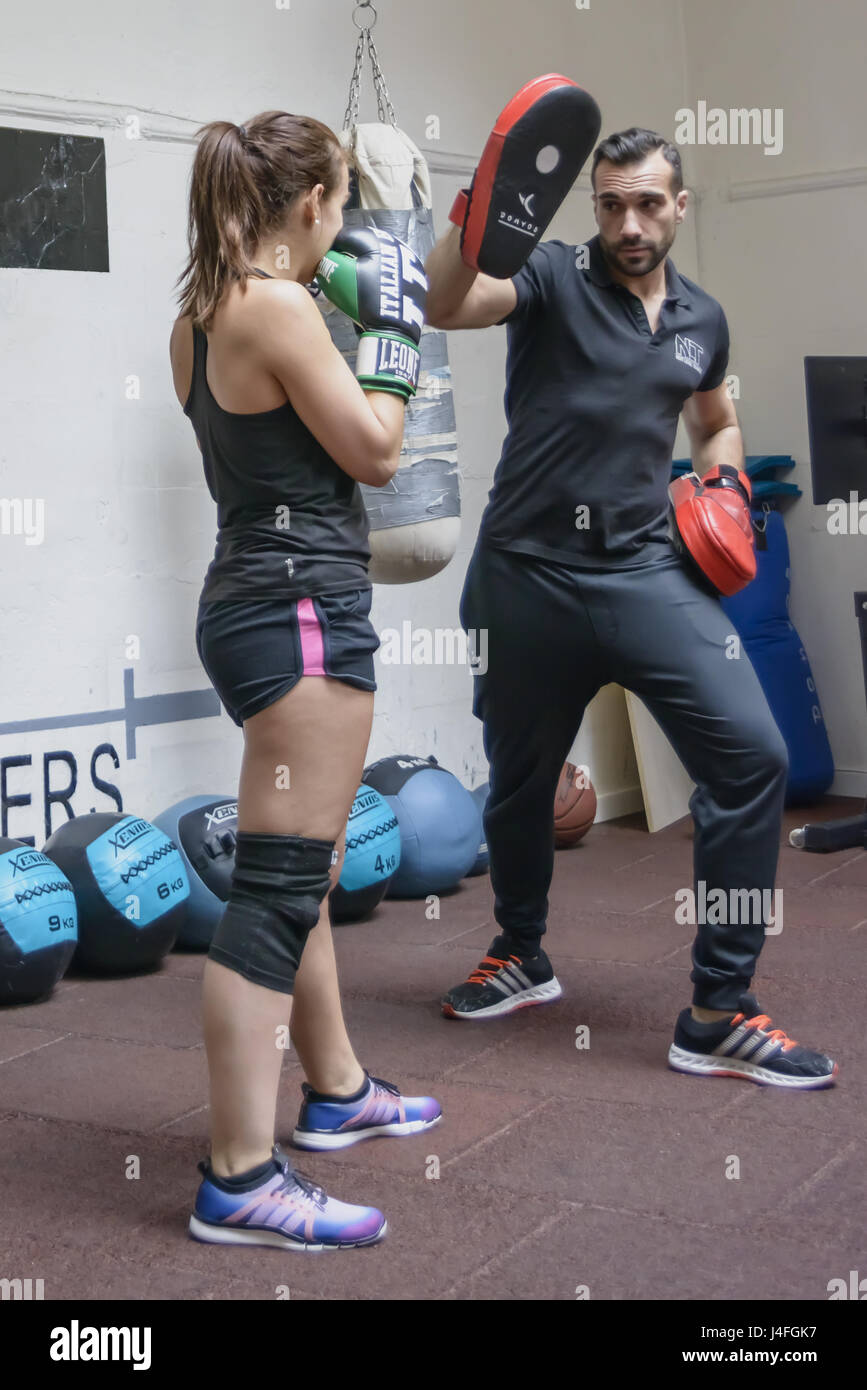 Girl in gym exercise fighting with master3 Stock Photo Alamy