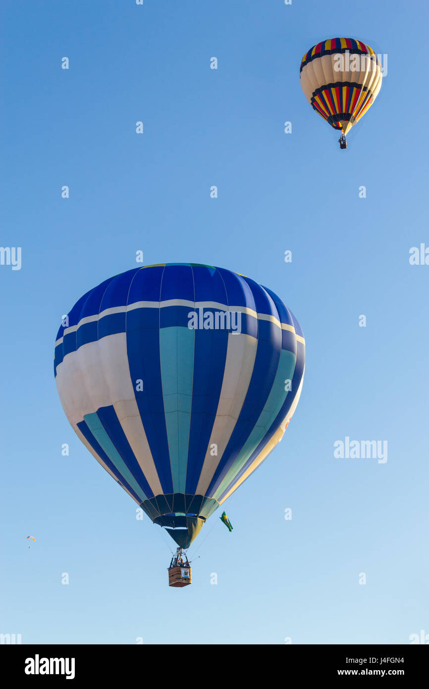 Two Colored hot air balloons flying in a blue sky Stock Photo - Alamy