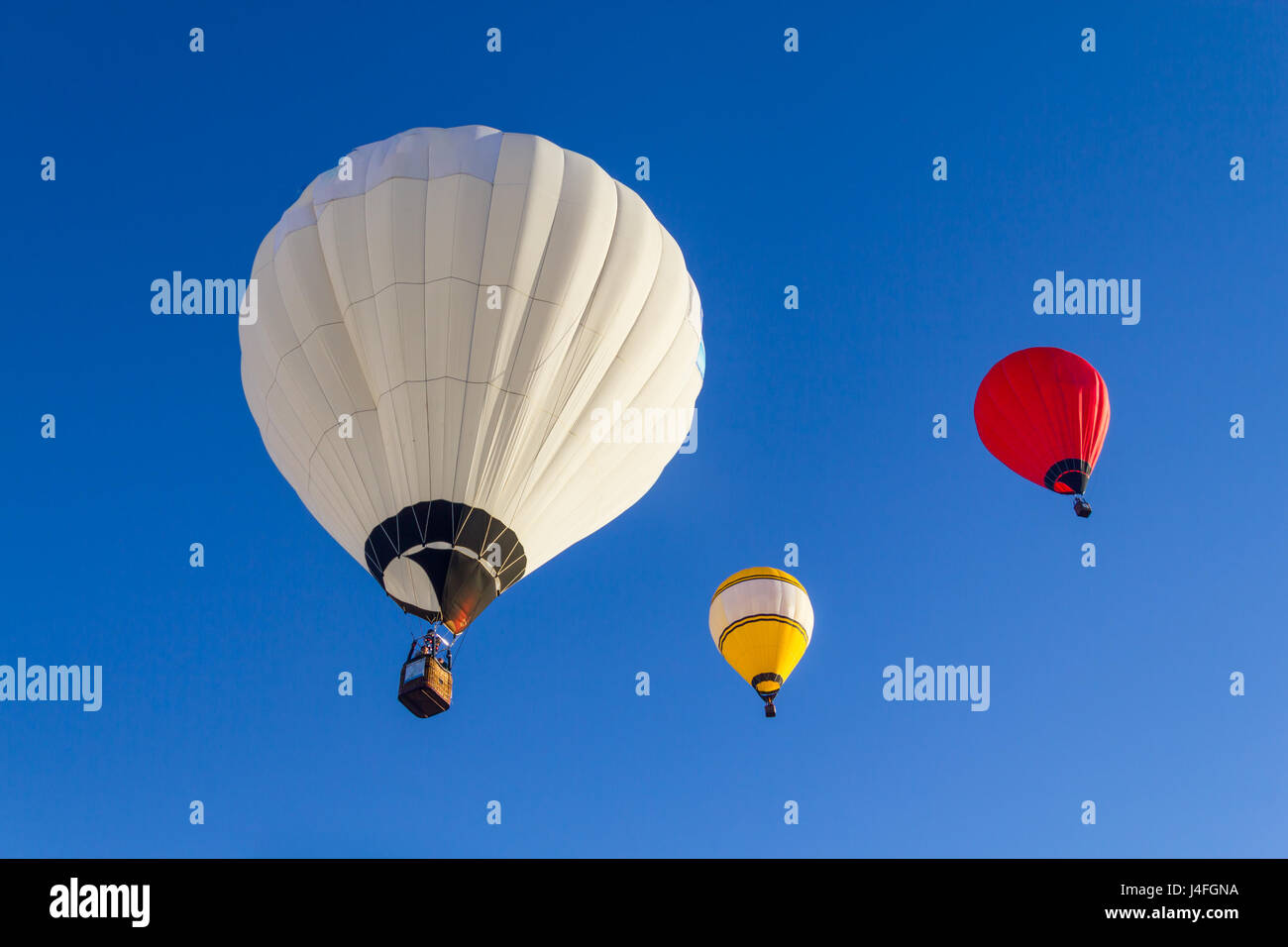 Group of Colored hot air balloons flying in a blue sky Stock Photo - Alamy