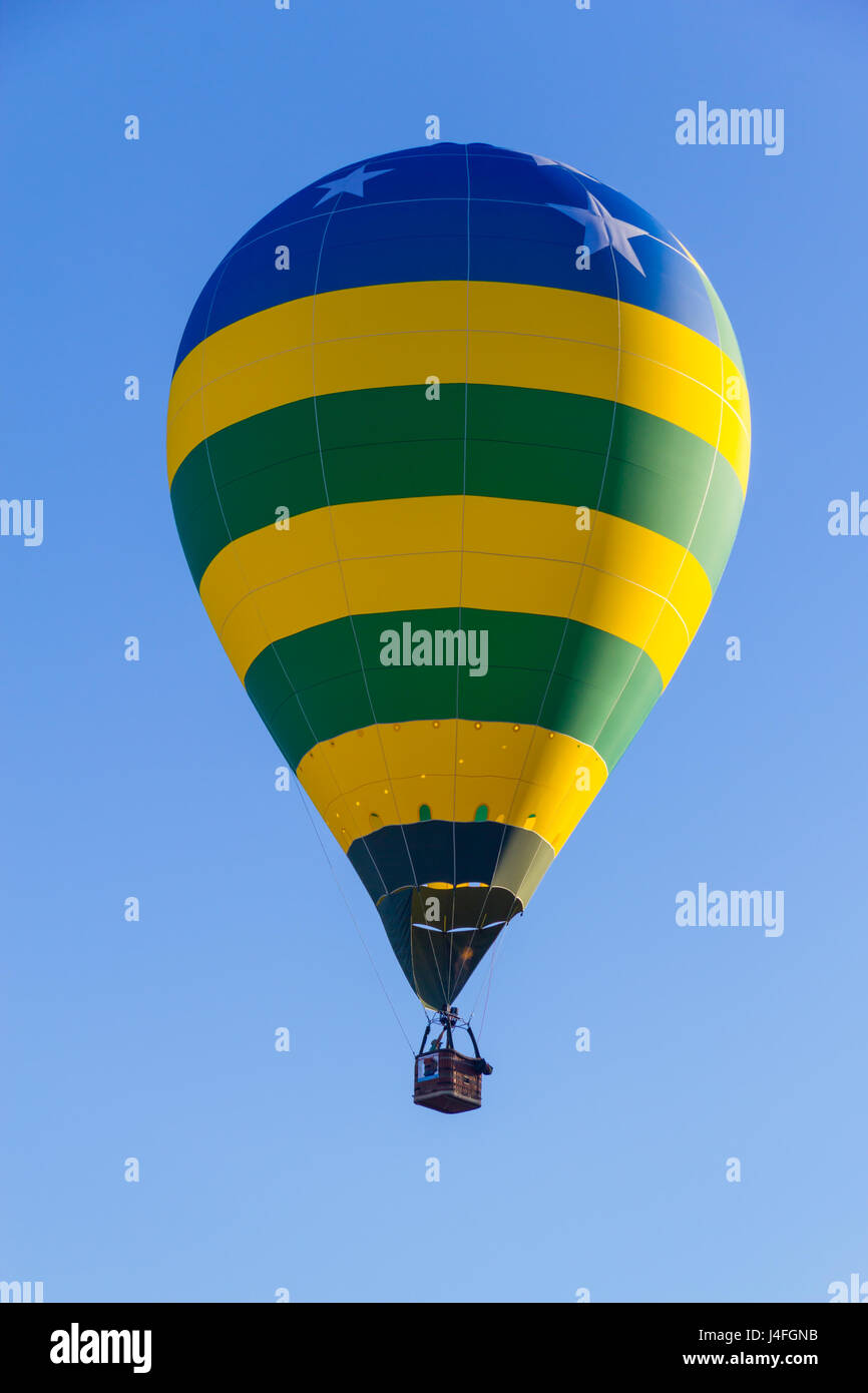 Colored hot air balloon flying in a blue sky Stock Photo - Alamy