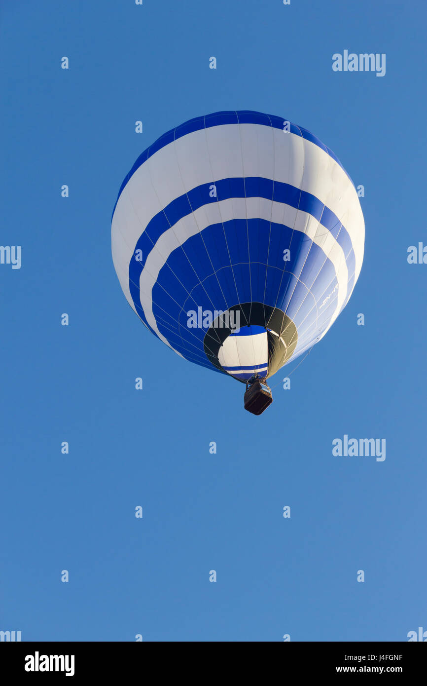 Colored hot air balloon flying in a blue sky Stock Photo - Alamy