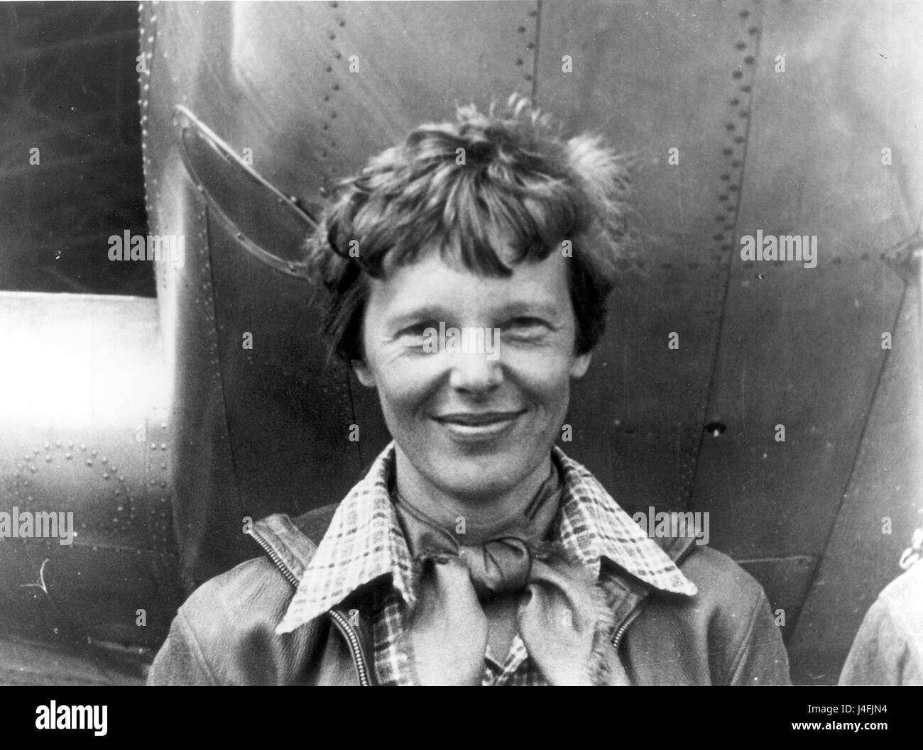Amelia Earhart standing under nose of her Lockheed Model 10-E Electra. Stock Photo