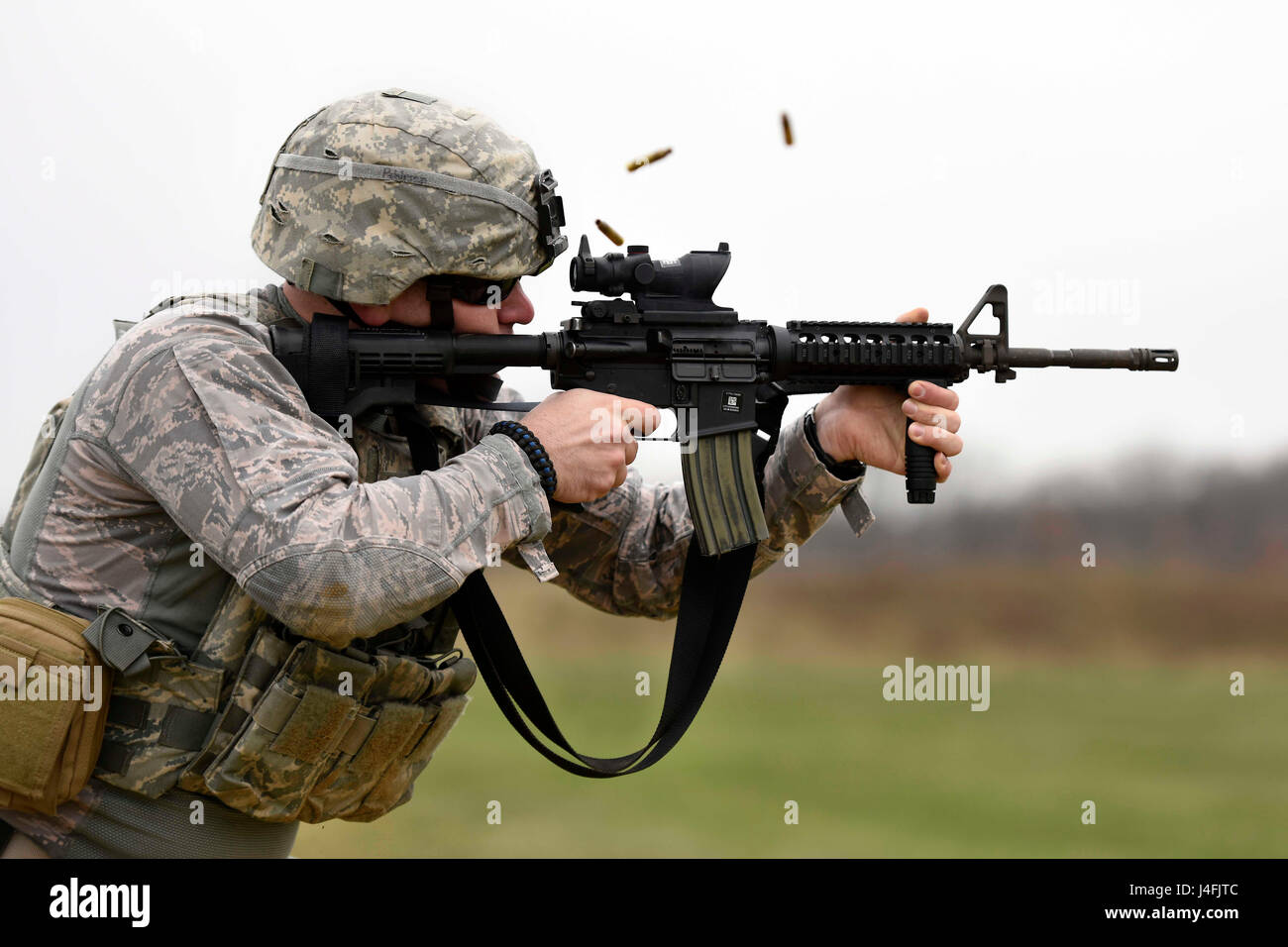 U.S. Air Force Senior Airman, a security forces specialist fires an M4 carbine rifle during target practice Stock Photo