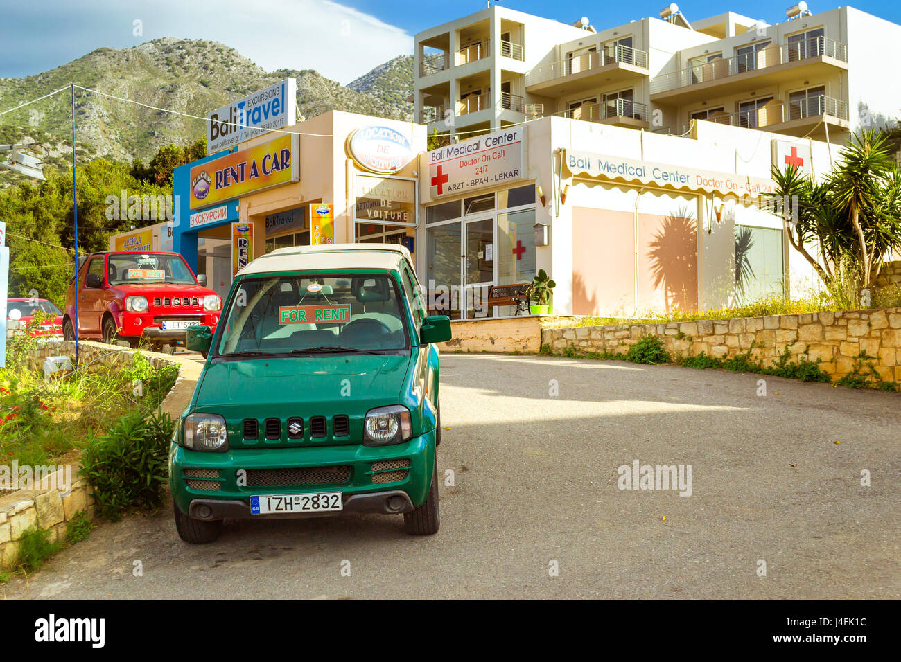 Bali, Greece - may 2, 2016: Rental all-wheel drive car Suzuki are parked on  sloping street leading to the sea, about office leasing transport. Resort  Stock Photo - Alamy