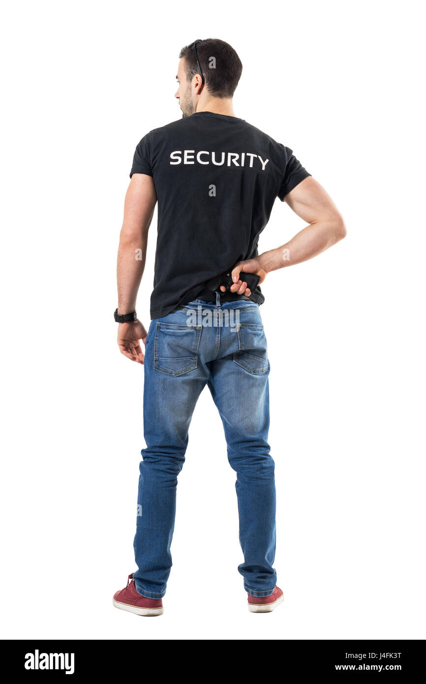 back view of alerted undercover cop or security agent reaching hand security agent