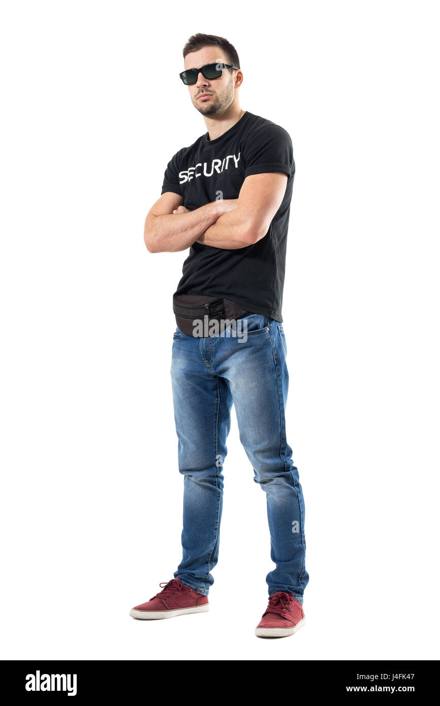 Tough macho undercover officer with crossed arms looking at camera. Full body length portrait isolated on white studio background. Stock Photo