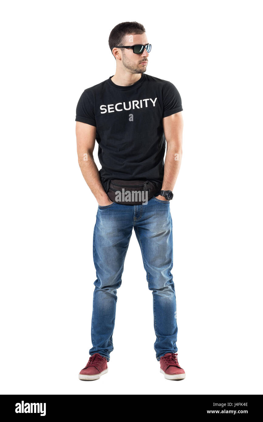 Undercover police officer in plainclothes with hands in pockets looking away. Full body length portrait isolated on white studio background. Stock Photo