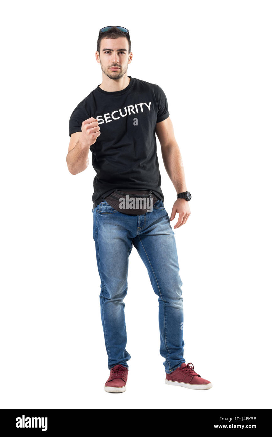 Young confident police officer in plain civilian clothes with clenched fist. Full body length portrait isolated on white studio background. Stock Photo
