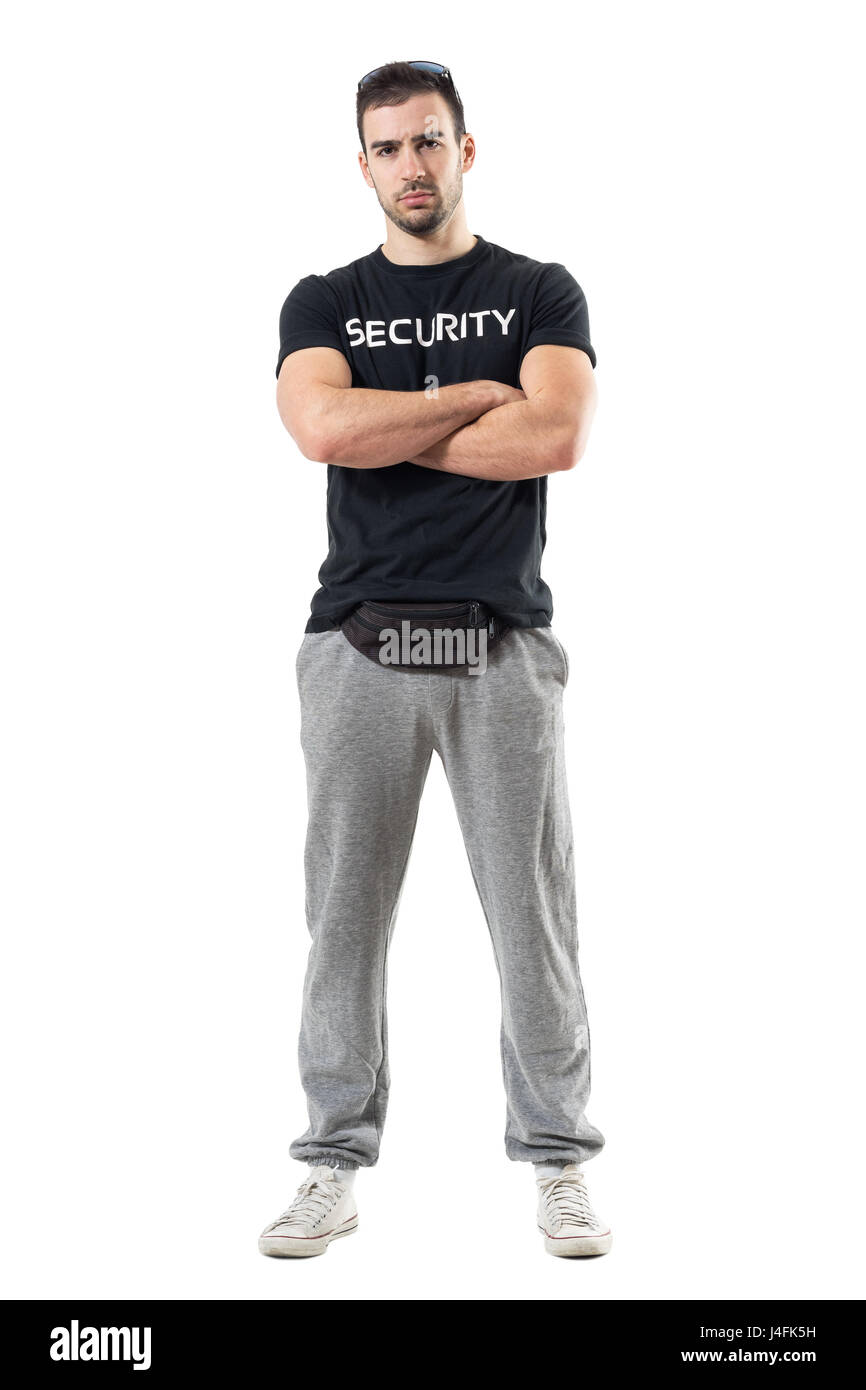 Tough macho bouncer wearing waist bag with crossed arms looking at camera. Full body length portrait isolated on white studio background. Stock Photo