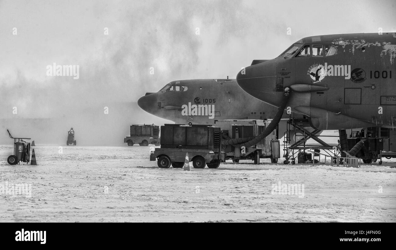 The 5th Civil Engineer Squadron removes snow from the flightline before a training sortie at Minot Air Force Base, N.D., Jan. 14, 2016. Bomber Airmen work around the clock in all weather conditions in order to provide B-52H Stratofortress firepower on demand. (U.S. Air Force photo/Airman 1st Class J.T. Armstrong) Stock Photo