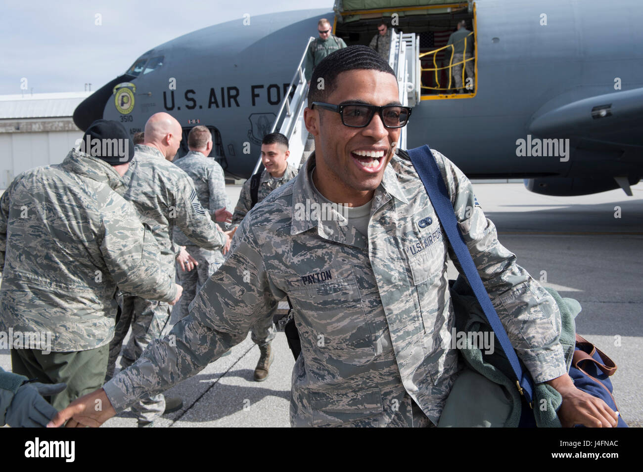 Senior Airman Chaz Payton, 434th Maintenance Squadron integrated instrument specialist, smiles after shaking hands with 434th Air Refueling Wing leadership and seeing his family, after returning to Grissom Air Reserve Base from a deployment to Southwest Asia Feb. 7, 2016. A total of 68 Airmen returned from a 4-month deployment in support of Operation Inherent Resolve. (U.S. Air Force photo/Tech. Sgt. Benjamin Mota) Stock Photo