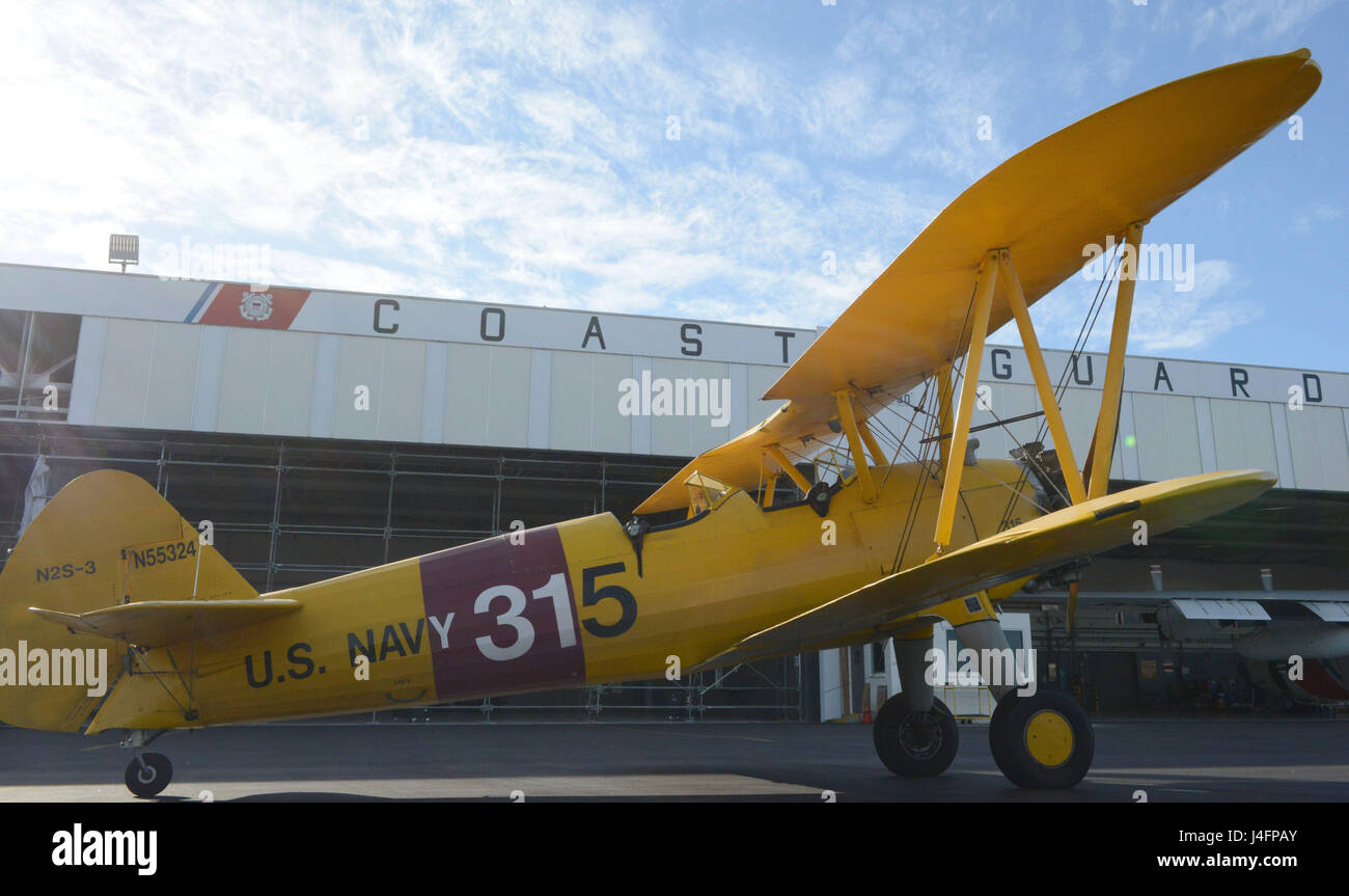 Lt. Cmdr. Harry Greene’s Boeing Stearman Kaydet Primary Trainer airplane sits on the tarmac at Coast Guard Air Station Barbers Point, Jan. 31, 2016. Greene is a helicopter pilot at Air Station Barbers Point and an aircraft enthusiast in his off-duty time. (U.S. Coast Guard photo by Petty Officer 2nd Class Tara Molle/Released) Stock Photo