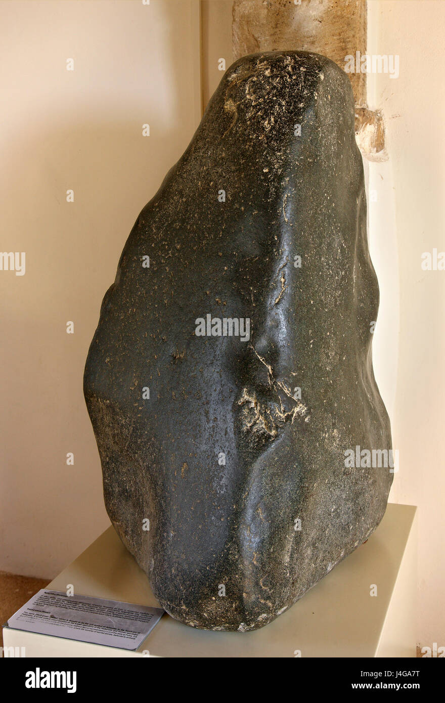 A Baetyl, a black-green volcanic sacred stone, thought to be the cult symbol of Aphrodite (Venus) in the sanctuary of Palaipaphos, Cyprus island. Stock Photo