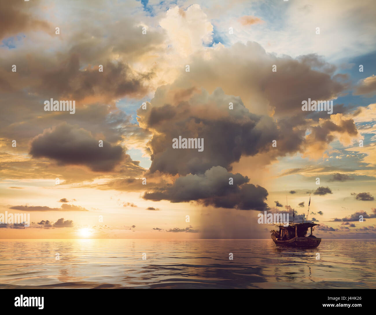 beautiful sunset over the old fishing boat Stock Photo - Alamy