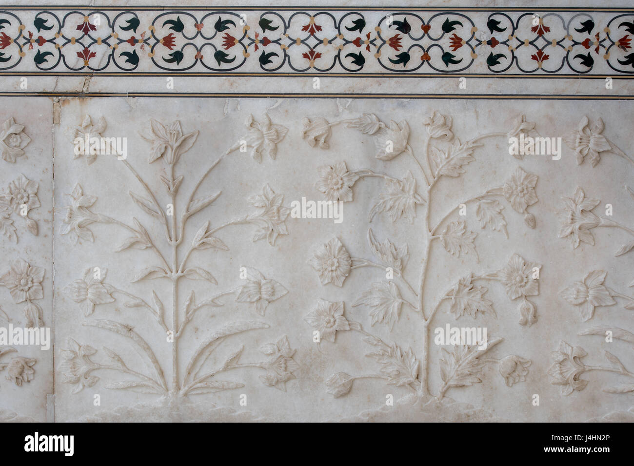 Delicate floral relief sculptures on the ivory marble walls of the Taj