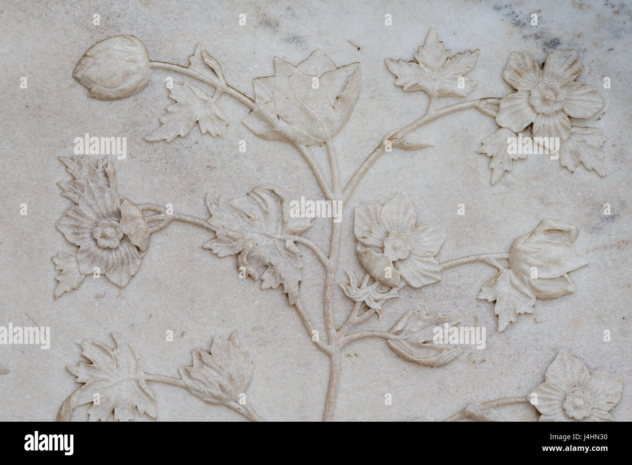 Delicate floral relief sculptures on the ivory marble walls of the Taj