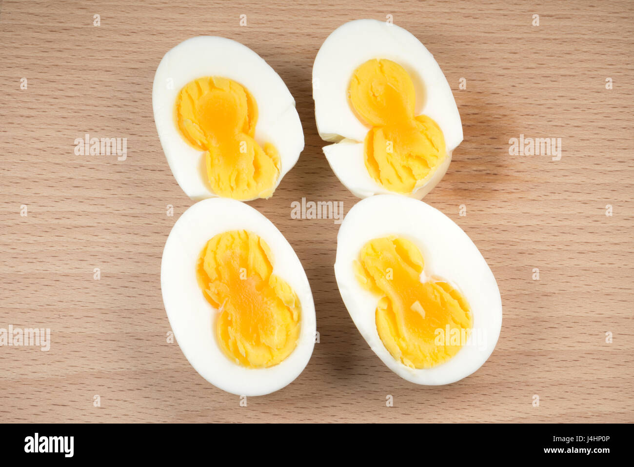 Two double yolk eggs on a wooden board Stock Photo - Alamy