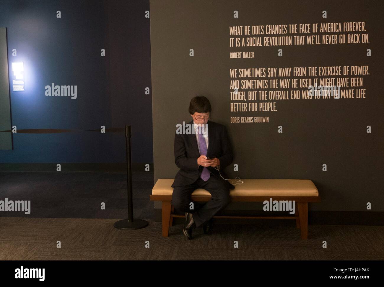Documentary filmmaker Ken Burns checks his phone in the lobby before a screening of his upcoming PBS documentary series The Vietnam War at the LBJ Presidential Library April 27, 2017 in Austin, Texas.     (photo by Jay Godwin/LBJ Presidential Library  via Planetpix) Stock Photo