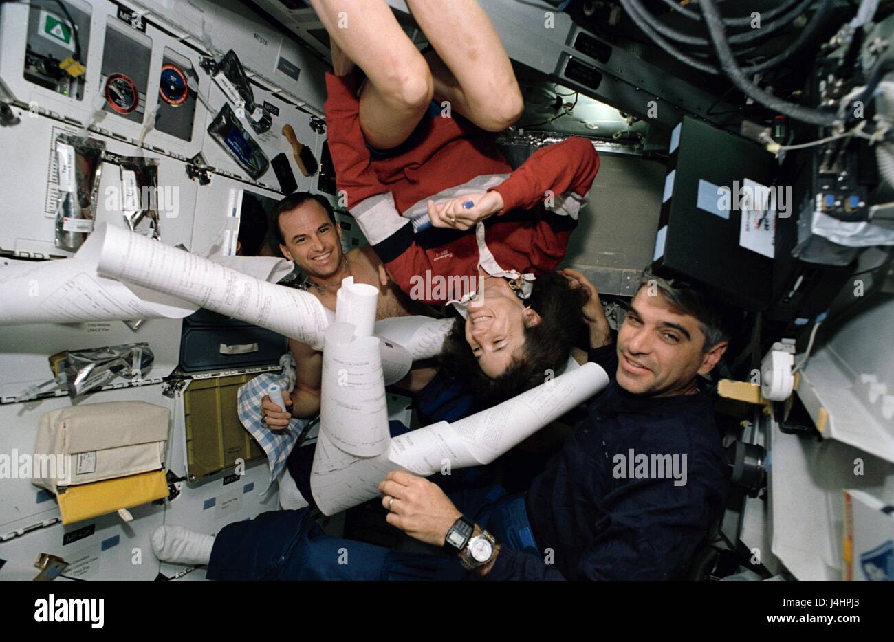 NASA STS-59 mission prime crew astronauts (L-R) Kevin Chilton, Linda Godwin, and Sidney Gutierrez receive a long TIPS mail message while aboard the space shuttle Endeavour April 9, 1994 in Earth orbit.     (photo by NASA   via Planetpix) Stock Photo