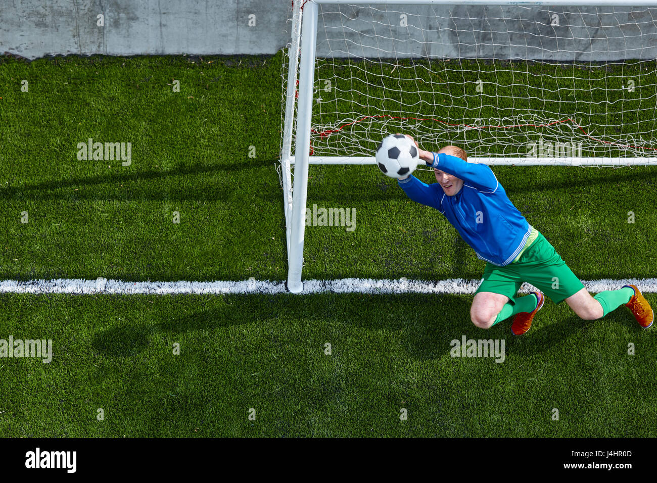 Soccer football goalkeeper making diving save Stock Photo Alamy