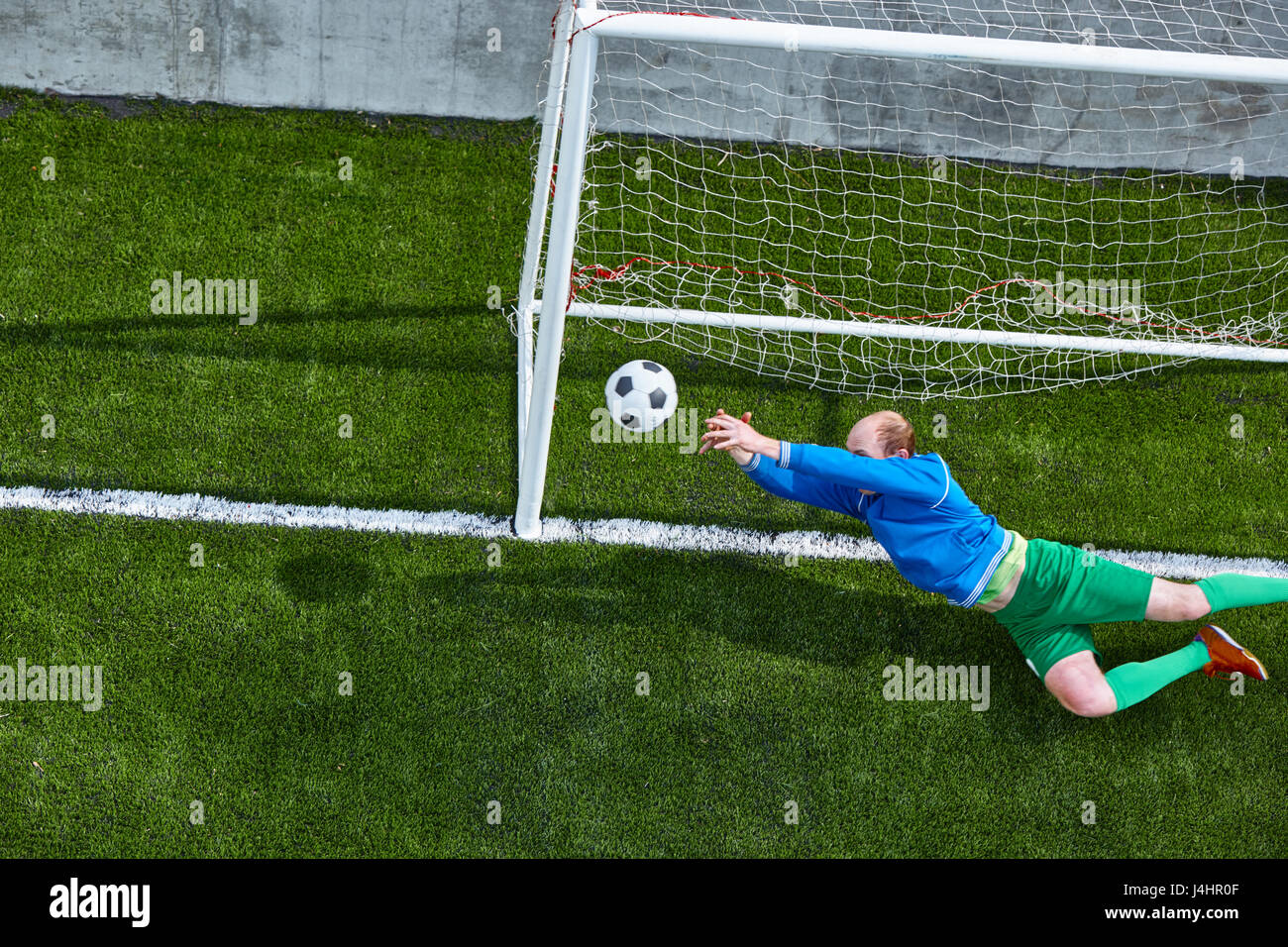 Soccer football goalkeeper making diving save Stock Photo Alamy