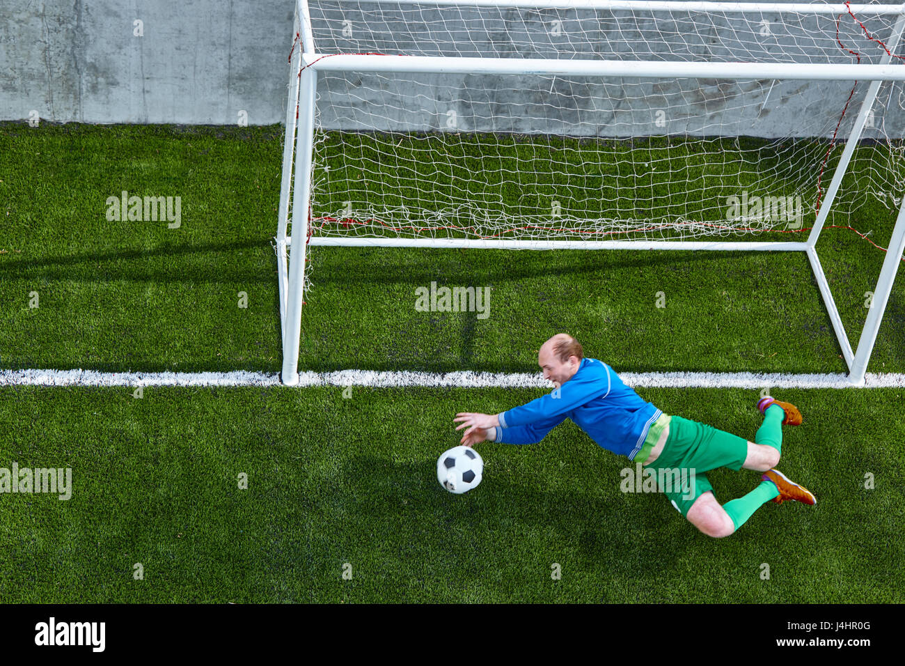 Soccer football goalkeeper making diving save Stock Photo Alamy