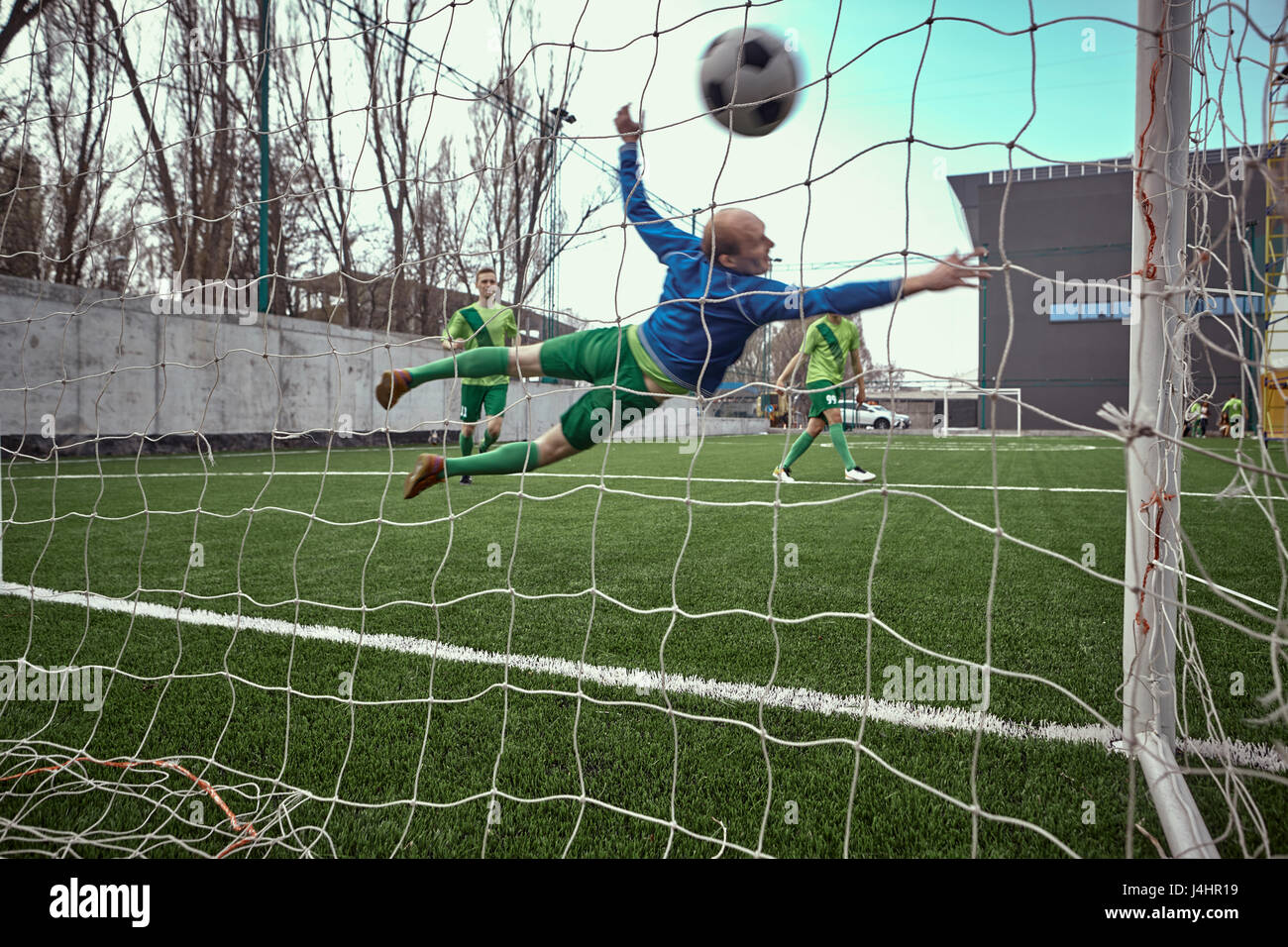 Soccer football goalkeeper making diving save Stock Photo Alamy