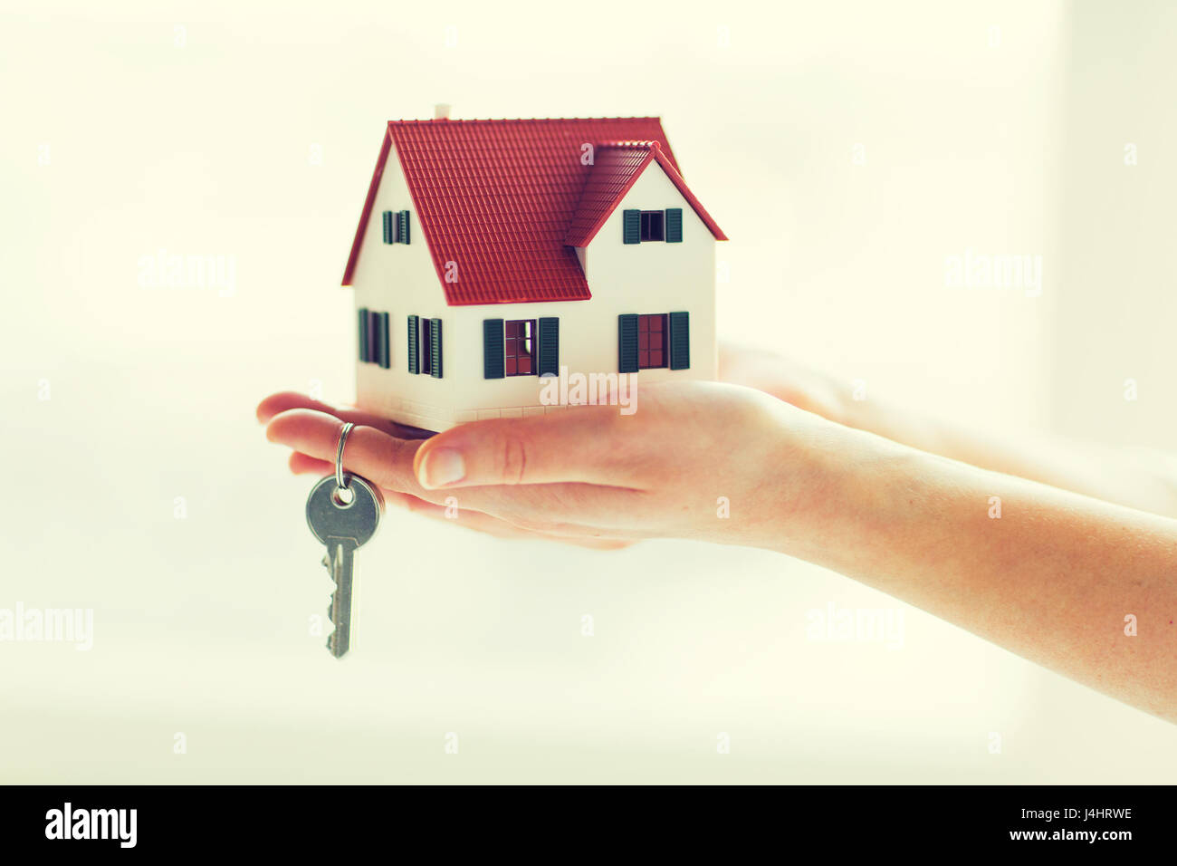 close up of hands holding house model and keys Stock Photo - Alamy