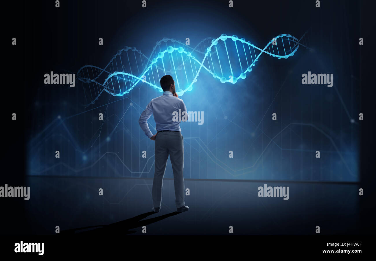 businessman looking at virtual dna molecule Stock Photo - Alamy
