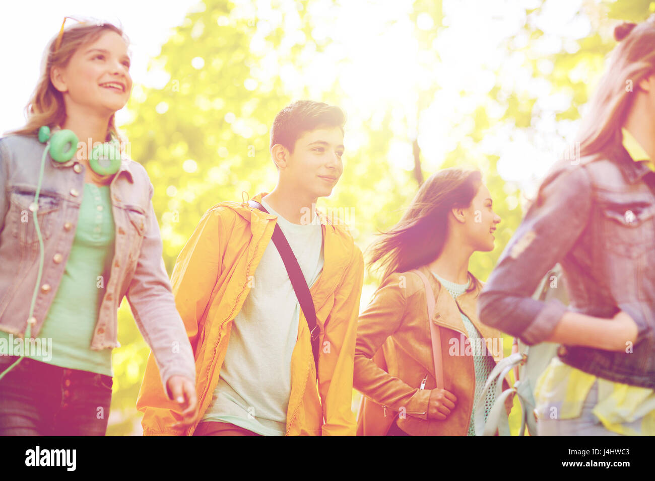 group of happy teenage students walking outdoors Stock Photo - Alamy