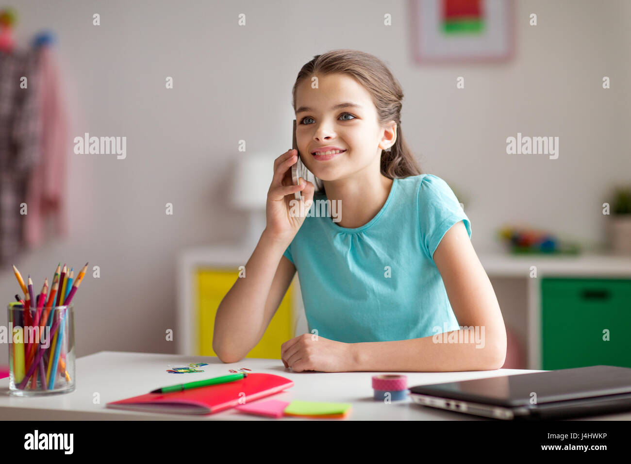 happy girl calling on smartphone at home Stock Photo