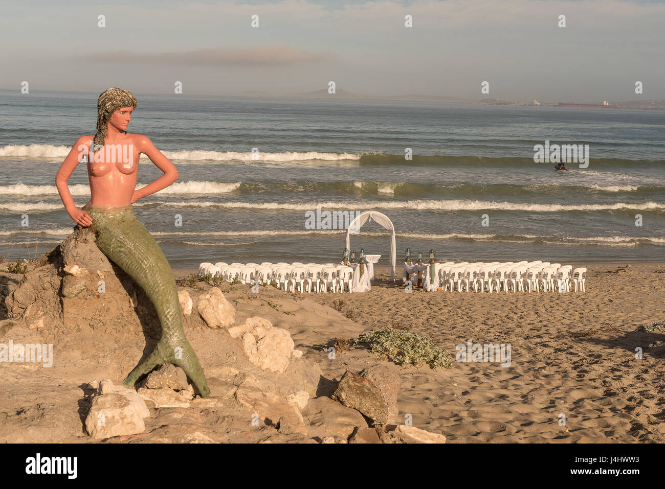 LANGEBAAN, SOUTH AFRICA - APRIL 1, 2017: Preparations for a wedding under the watchful eyes of a mermaid on the beach at Boesmanland Plaaskombuis in L Stock Photo