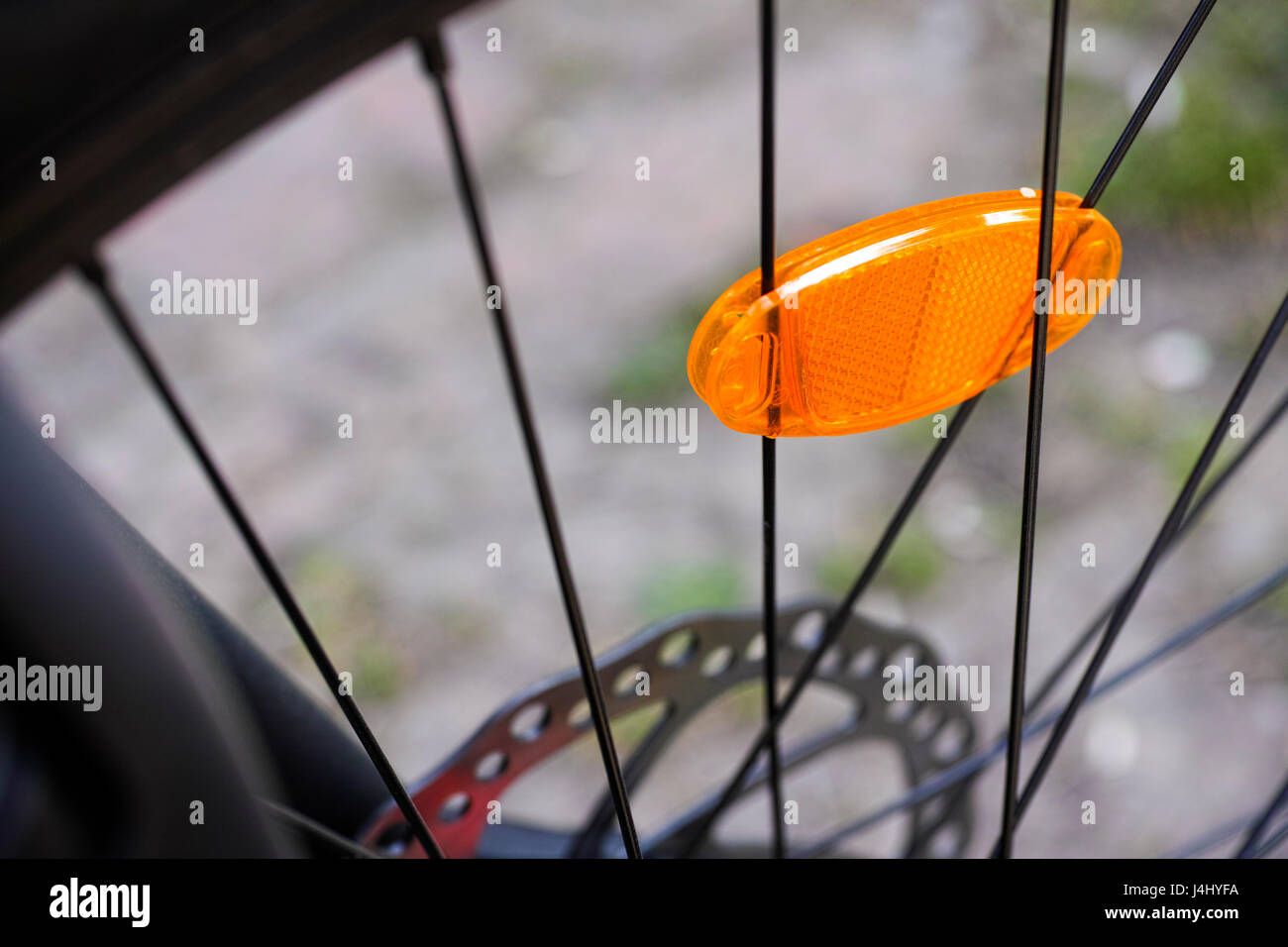Bicycle wheel with orange reflector. Closeup Stock Photo Alamy