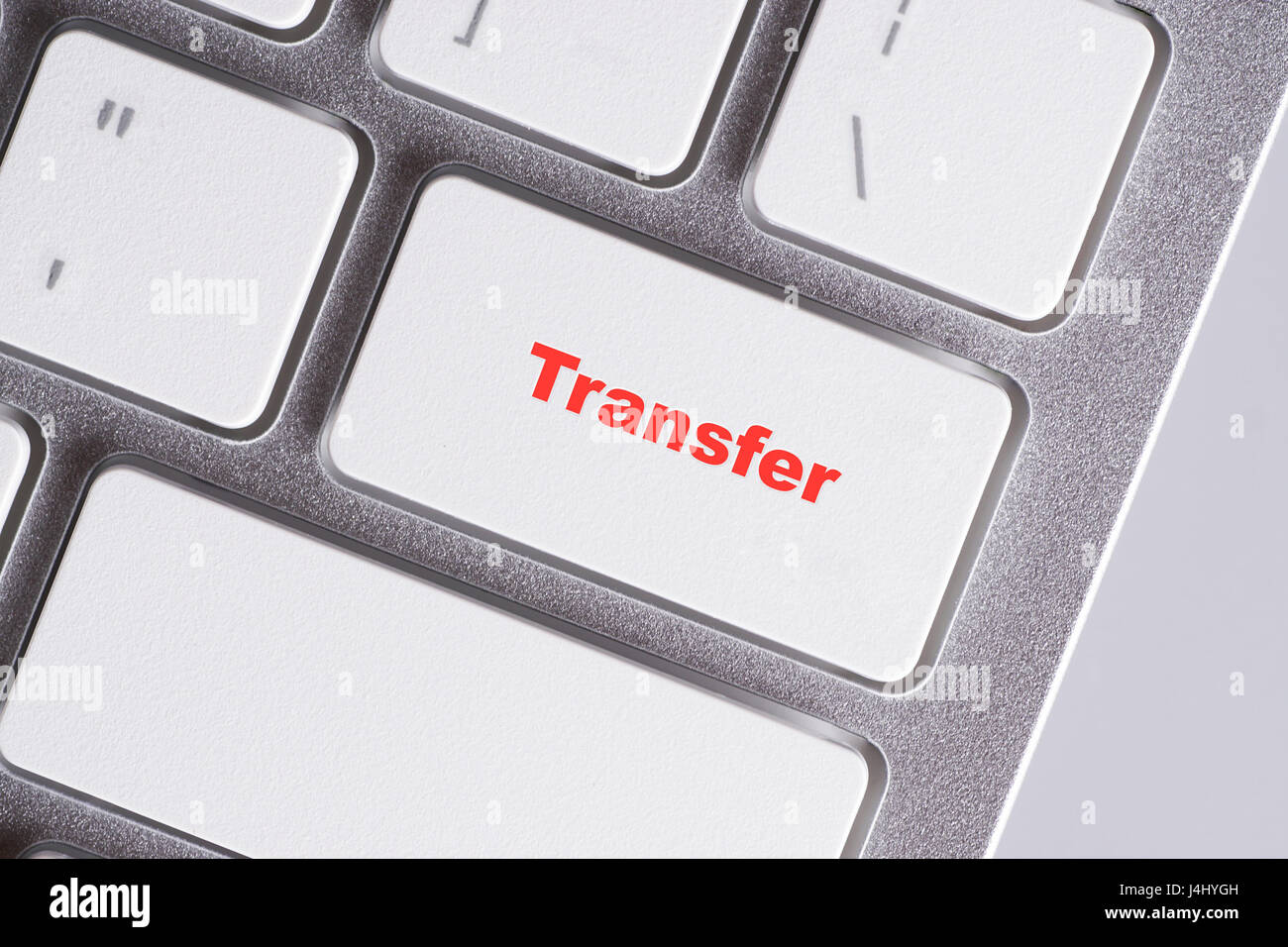 'Transfer' red words on white keyboard - online, education and business concept Stock Photo