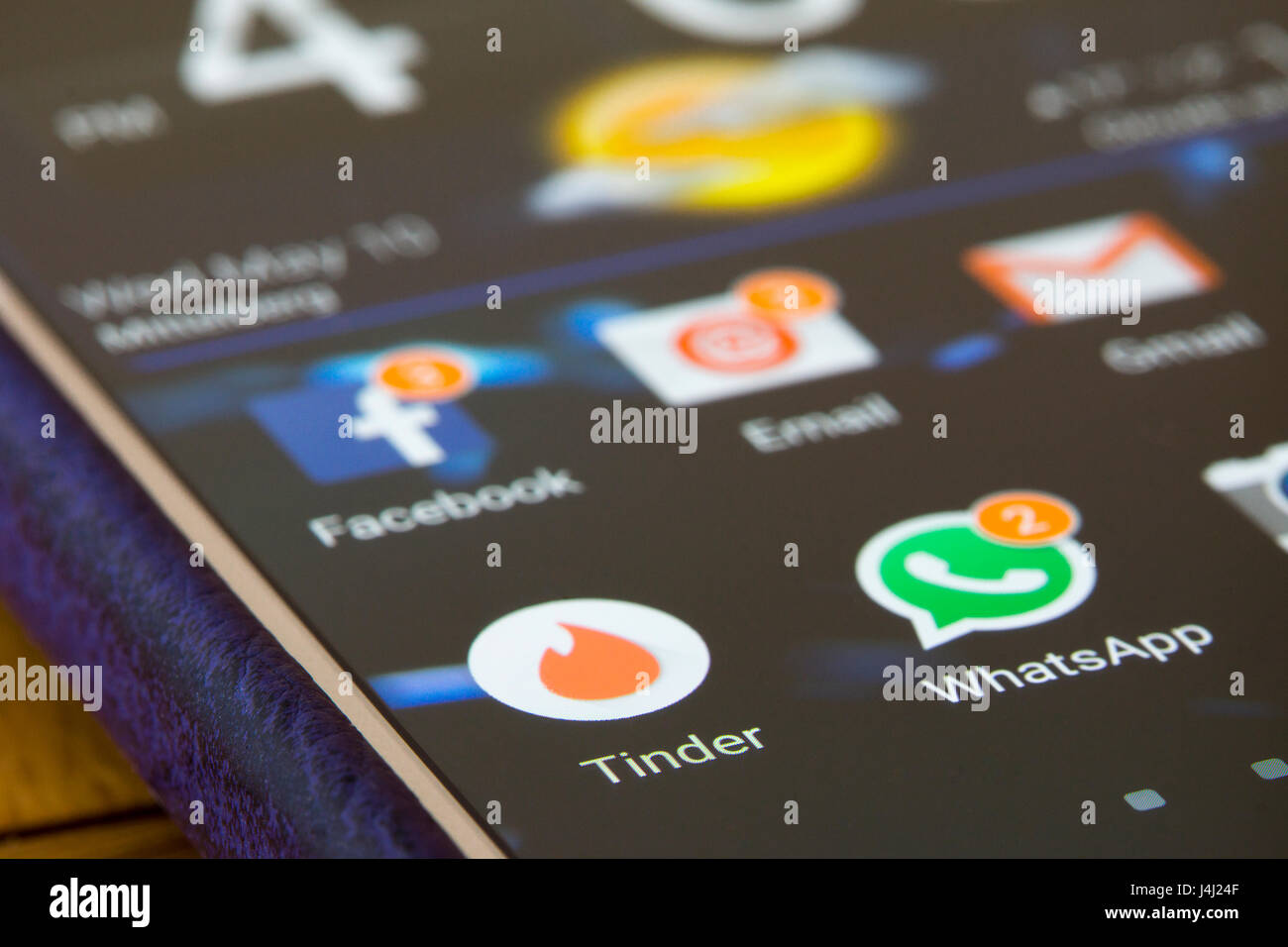 A closeup on a smartphone screen focused on the Tinder app Stock Photo