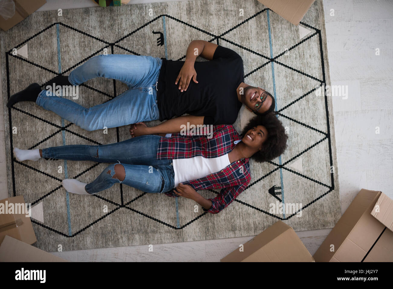 Top view of attractive young African American couple moving, holding ...