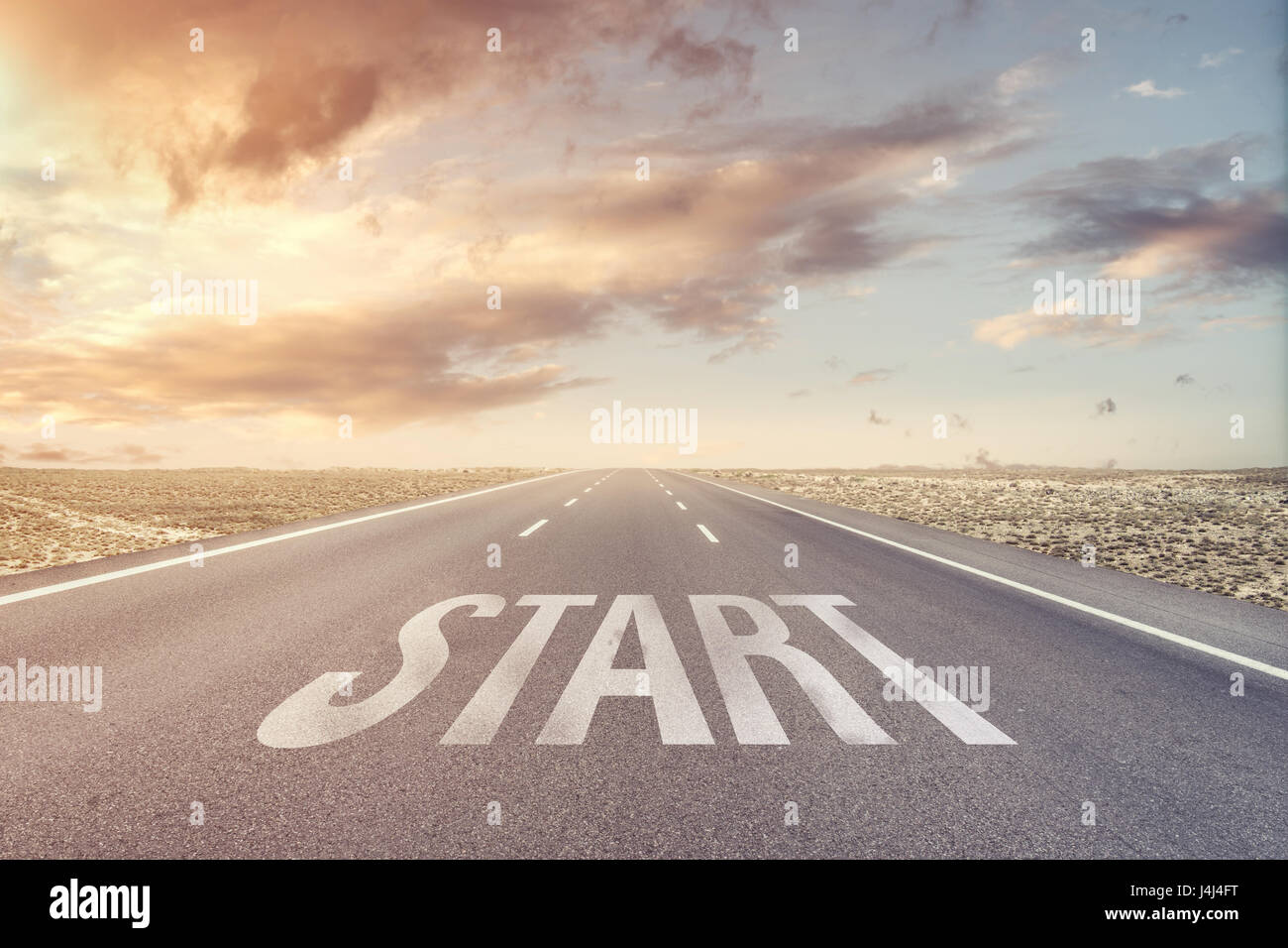 Conceptual Image with the Word Start on a Straight Desert Road to the Horizon Stock Photo