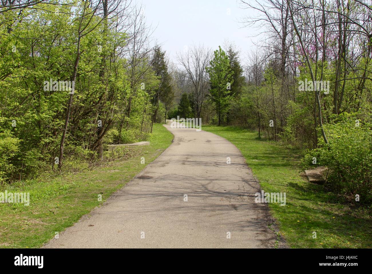 The sunny spring day at the park on the trails and by the lake. Stock Photo