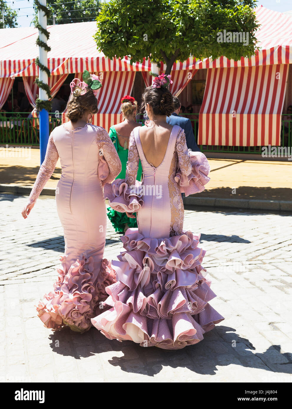 Seville, Seville Province, Andalusia, southern Spain. Feria de Abril, the  April Fair. Young women wearing flamenco dresses Stock Photo - Alamy