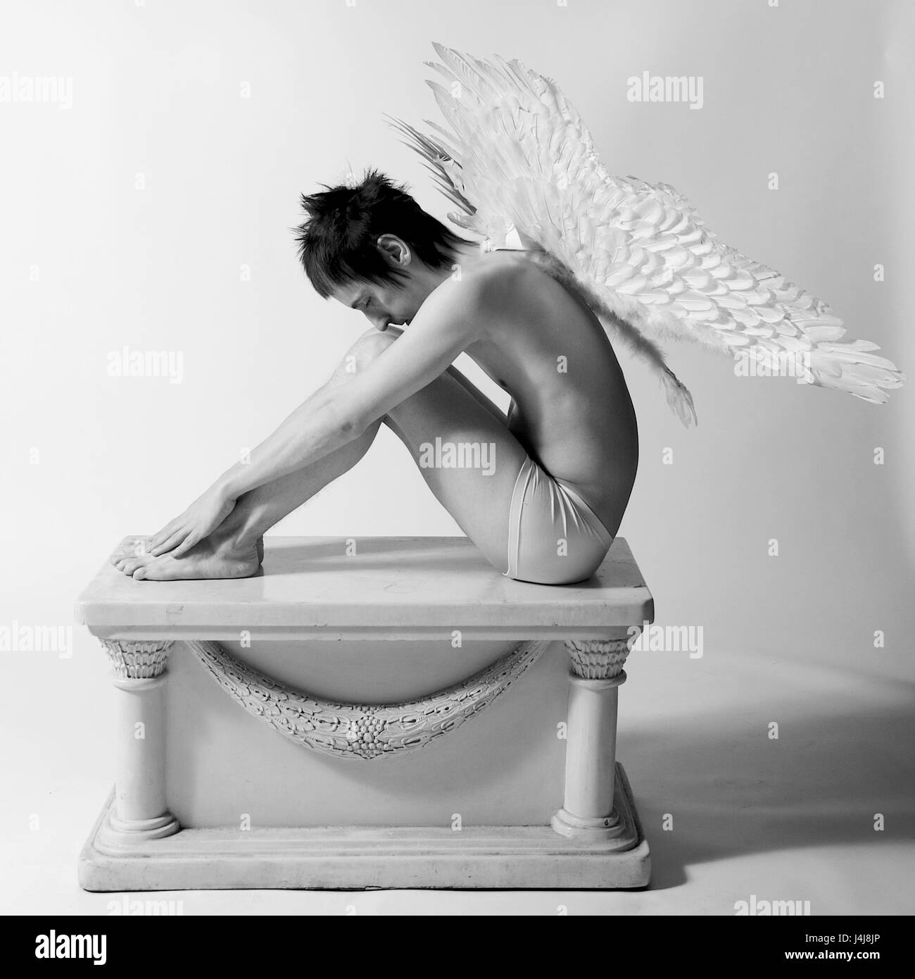 Young man in the studio - fashion shoot with angel wings Stock Photo