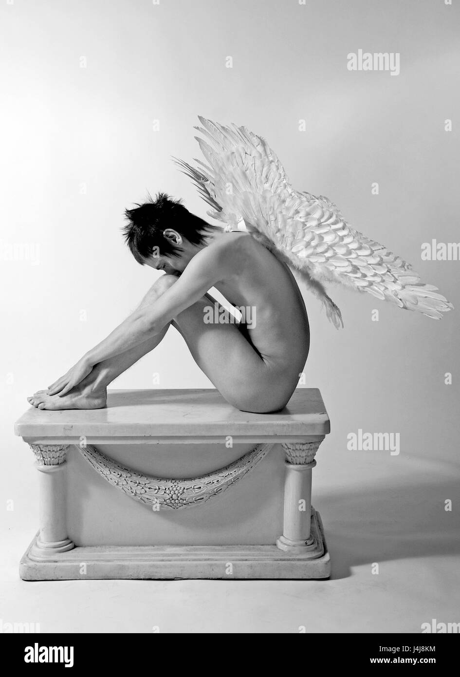 Young man in the studio - fashion shoot with angel wings Stock Photo