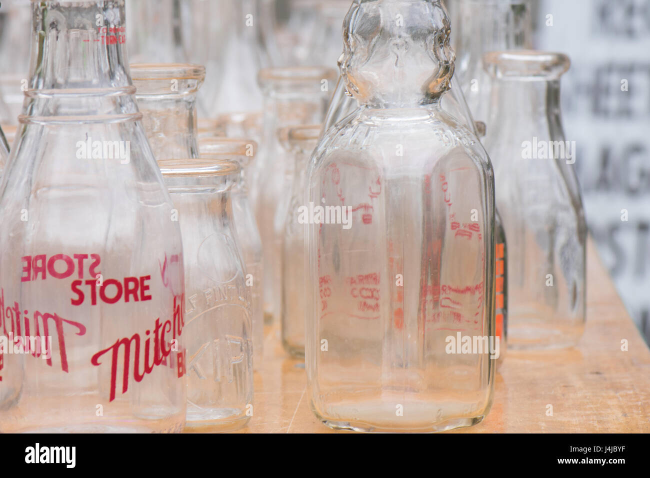 Looking through display of vintage milk bottles. Stock Photo