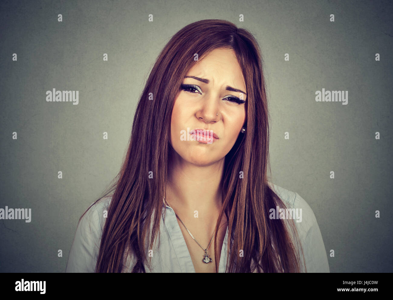 Disgusted woman isolated on gray background Stock Photo