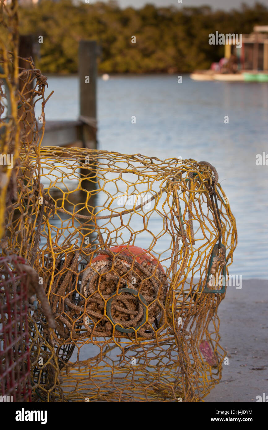 Fishing net sits on dock waiting for next boat Stock Photo