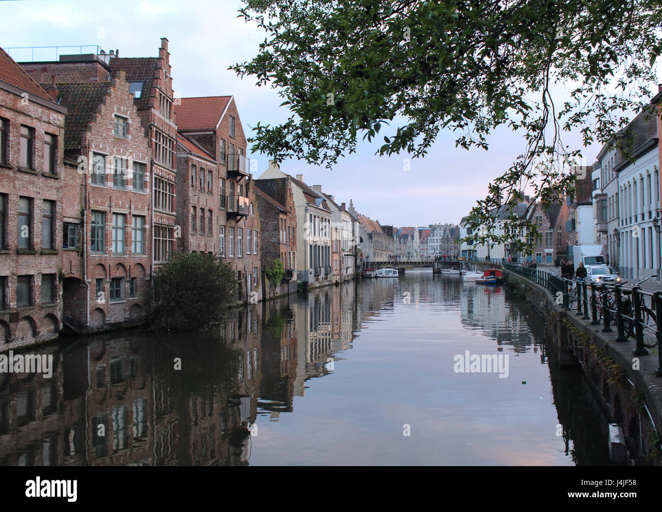 GENT, BELGIUM, APRIL 07 2017: Evening view of the water and historic buildings from the Kraanlei in Gent. Gent has a historic city centre and is a hug Stock Photo
