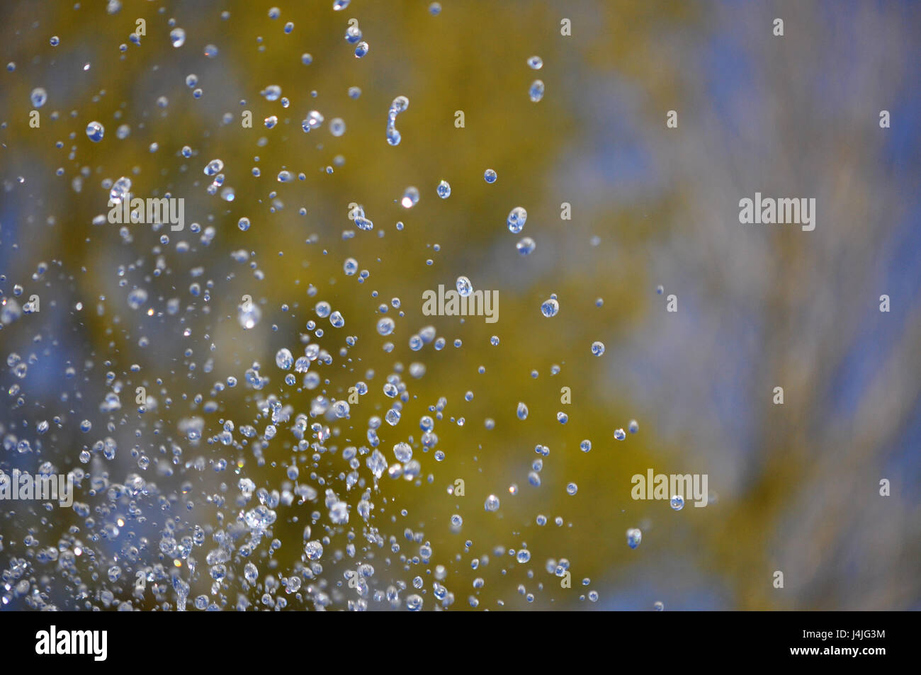 water drops from fountain in motion on the colorful backgruond - water in motion Stock Photo