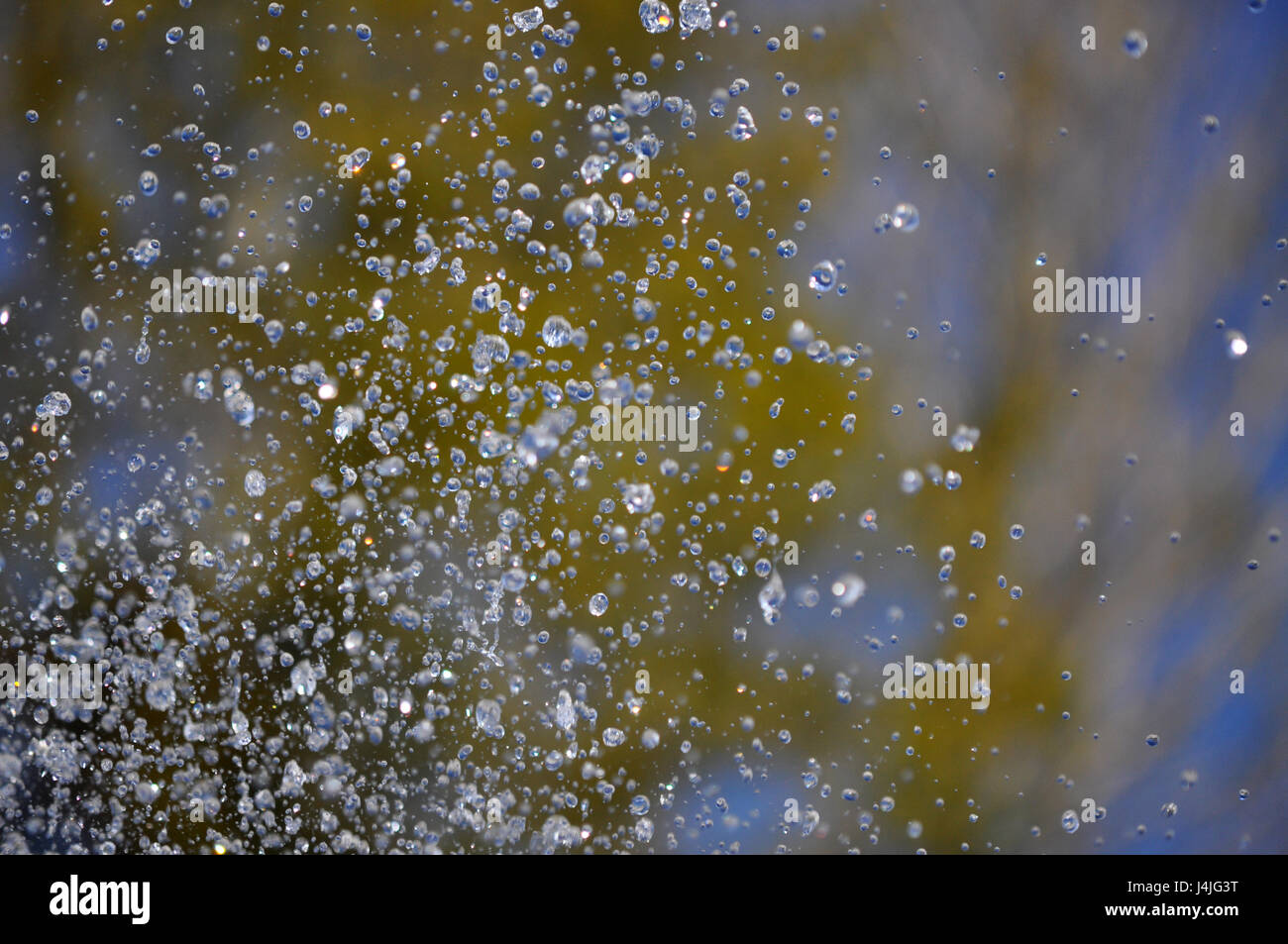 water drops from fountain in motion on the colorful backgruond - water in motion Stock Photo